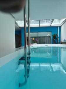 a swimming pool with a view of a house at M Costa Nova in Costa Nova