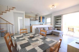 a kitchen and living room with a table and a couch at Apartment El Medano Sunrises in El Médano