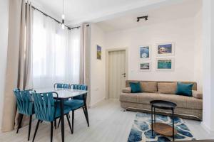 a living room with a table and a couch at Apartmani Oleander in Bar