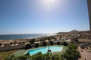 a view of a swimming pool and the beach at Apartment El Medano Sunrises in El Médano