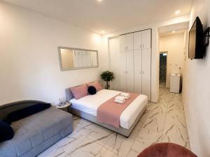 a bedroom with a large bed and a couch at Banićević APARTMANI in Đenovići