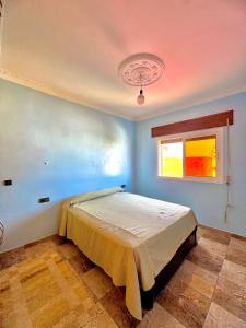 a bedroom with a bed in a room with a window at اقامة الابرار in Oued Laou
