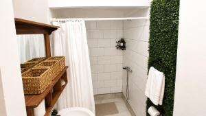 a bathroom with a shower with a white shower curtain at Milagro Andino in Arica