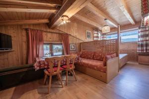 a living room with a couch and a table at Ciasa Cianins in San Vigilio Di Marebbe