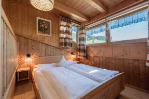 a bedroom with a bed in a room with a window at Ciasa Cianins in San Vigilio Di Marebbe