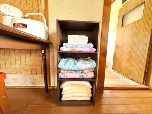 a closet with towels and towels in a room at 長峰駅から徒歩3分ゲストハウスオオワニ in Ōwani +31 photos