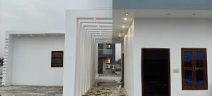 a hallway of a building with white walls at Hotel Golden Spark in Jewar