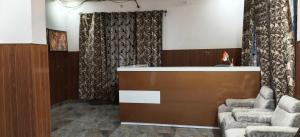 a waiting room with two chairs and a desk at Hotel Golden Spark in Jewar