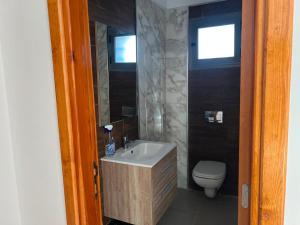 a bathroom with a sink and a toilet at Dar El Baraka in Ghar el Fabs +11 photos