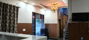 a living room with a tv and a window at Hotel Golden Spark in Jewar +15 photos