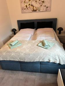 a bed with two towels on top of it at Kontinental C in Bad Harzburg