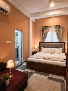 a bedroom with a large bed and a window at Cleopatra Rest House in Nilaveli