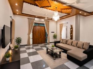 a living room with a couch and a table at Cleopatra Rest House in Nilaveli