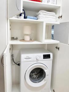 a white laundry room with a washing machine at Apartment Melina in Plužine