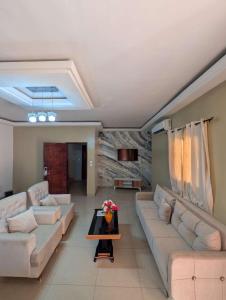 a living room with couches and a table at Résidence ivoire in Yamoussoukro