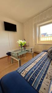 a bedroom with a bed and a table and a television at Jagienka in Łeba