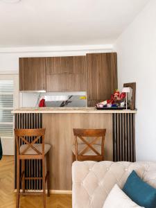 a kitchen with a couch and a counter top at Apartment Melina in Plužine +10 photos