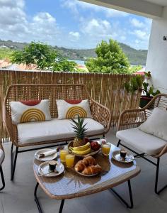 a tray of food on a table on a patio at Villa Ma Cherry in Le Diamant