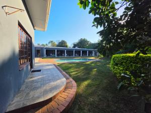 a house with a courtyard with a swimming pool at Southernstar 10 st Davids road in Arcadia