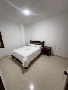 a bedroom with a bed and a table in it at ConfortTrust Hotel in Ocaña