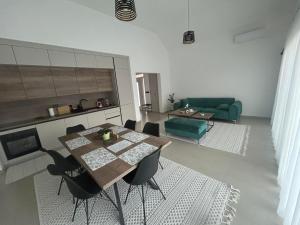 a living room with a table and a green couch at Villa Elaris in Bihać