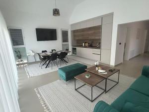 a living room with a green couch and a table at Villa Elaris in Bihać