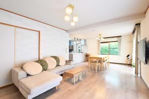 a living room with a couch and a table at Fuka in Beppu -New Open January2026 in Beppu
