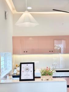 a kitchen with a framed picture on a counter at Meadows Homestay Elite in Madurai