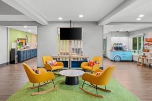 a waiting room with chairs and a table in a store at Spark by Hilton Brunswick in Brunswick