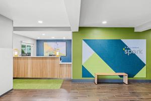 a waiting area with a bench in a lobby at Spark by Hilton Brunswick in Brunswick