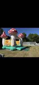 a group of three giant mushrooms in a playground at Bahia 2 in Le Faulq