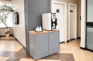 a coffee machine sitting on a counter in a room at Treville Hotel in Caràzinho