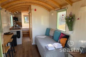 a small room with a couch in a tiny house at Sea Farm Stays in Broadstairs +51 photos