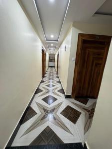 a hallway with a tiled floor in a building at Pari Shree Hotel And Banquet in Rānchī