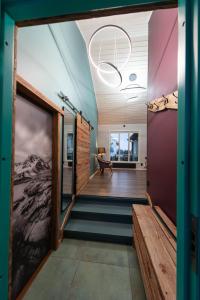 a hallway of a house with a staircase and a window at Lofoten Green House in Ramberg