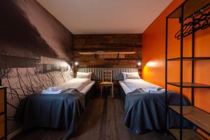 a room with two beds in it with a wall at Lofoten Green House in Ramberg +33 photos