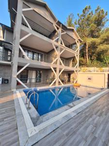 an apartment building with a swimming pool in front of it at MAİ Sarıgerme in Sarigerme