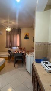 a kitchen with a stove and a table in a room at Dar Bouanani in Asilah