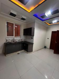 a large kitchen with a sink and a stove at Regal Heights in Bhurban