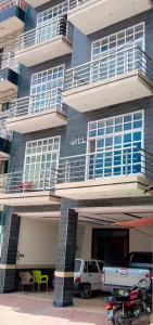 a building with cars parked in front of it at Regal Heights in Bhurban