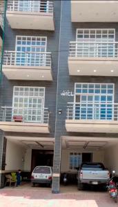 a building with cars parked in front of it at Regal Heights in Bhurban +2 photos