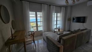 a living room with a couch and a table at Carte Postale Trikeri in Trikeri