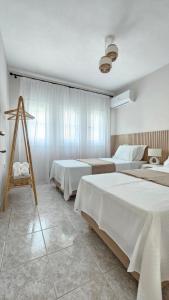a bedroom with two beds and a tripod in it at Carte Postale Trikeri in Trikeri