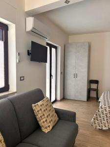 a living room with a couch and a tv at Civico 44 in Castelmezzano