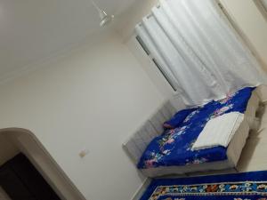a small bedroom with a bed and a window at Mohammad hostel in Ma‘ābīlah
