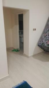 an empty room with a bed and a hallway at Mohammad hostel in Ma‘ābīlah