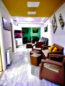 a living room with couches and a flat screen tv at Hergla Diamond Kais in Sousse