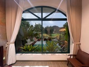 a window with a view of a pool at Mountainview tam coc villa in Vũ Lâm