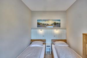 a hospital room with two beds in it at Haus Schildt, FeWo 5 in Duhnen