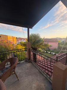 a balcony with two chairs and a view at Apartman Damir in Čeluga